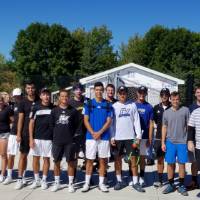 Alumni and current tennis players pose for a photo